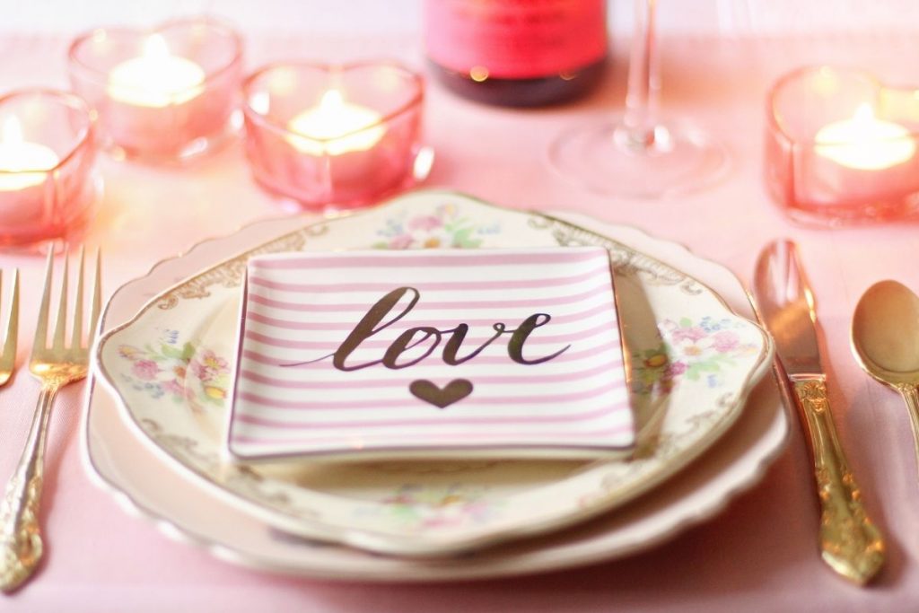 Two white plates with "love" written on lined paper