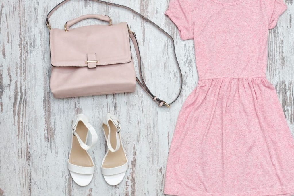 Pink dress with a pink handbag and white sandals